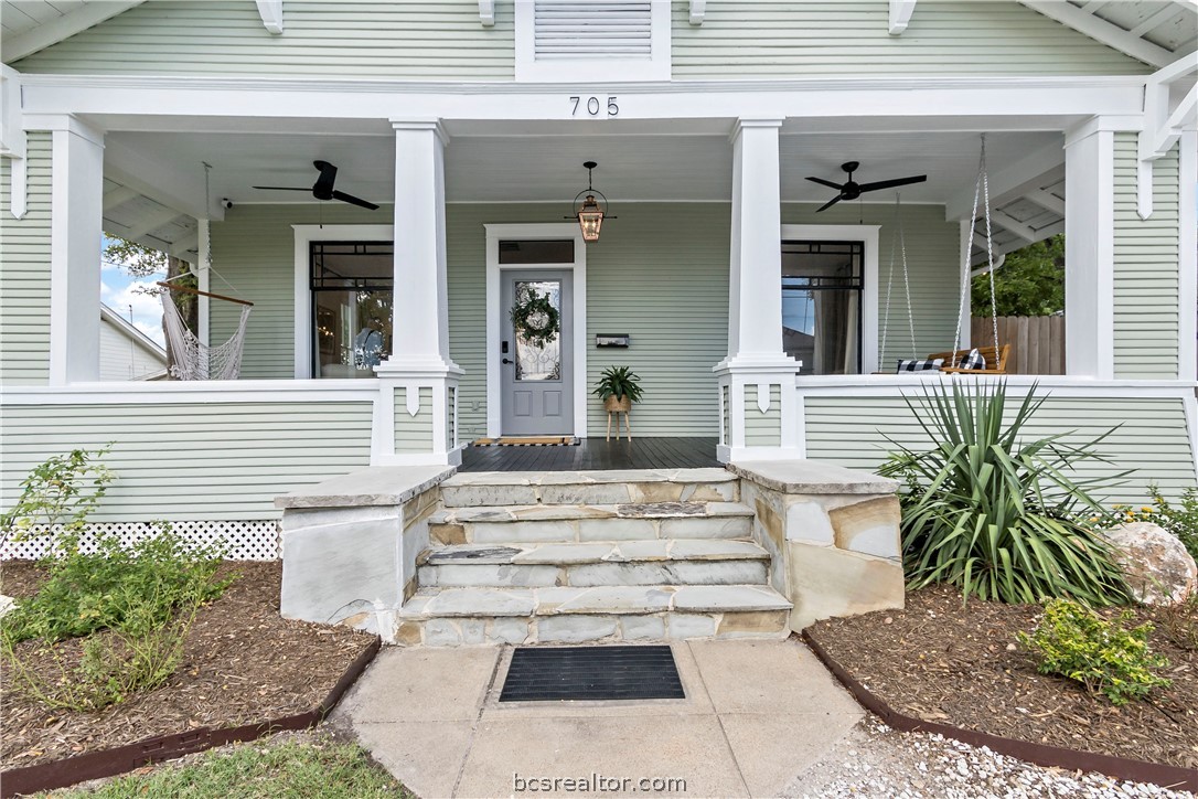 705 South Bryan Avenue Bryan, TX 77803 - Photo 5 of 47 a view of a house with potted plants and a table and chairs