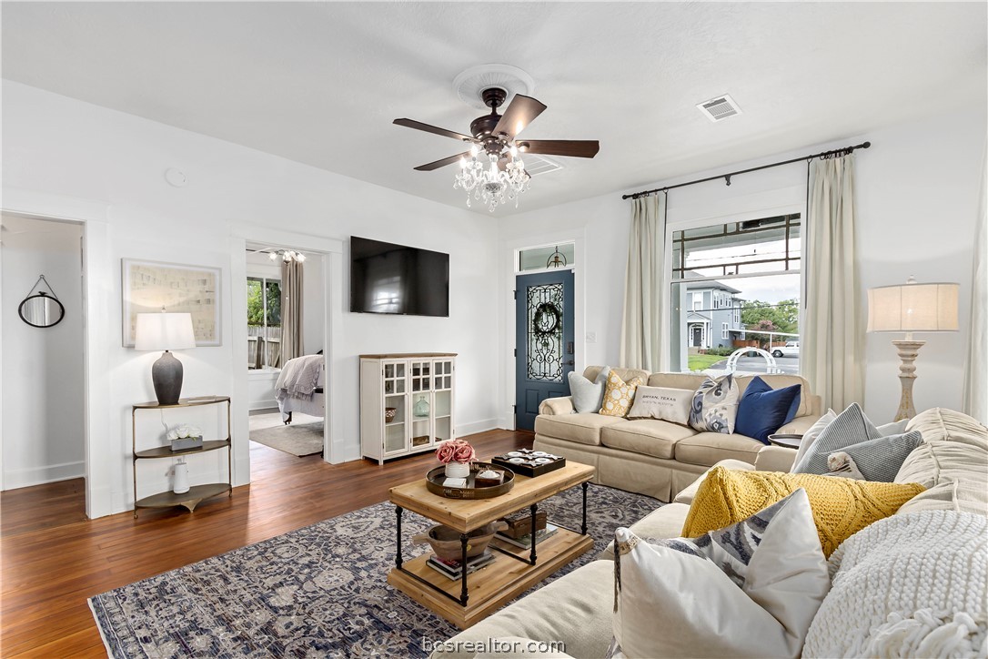 705 South Bryan Avenue Bryan, TX 77803 - Photo 10 of 47 a living room with furniture a ceiling fan a flat screen tv and a large window