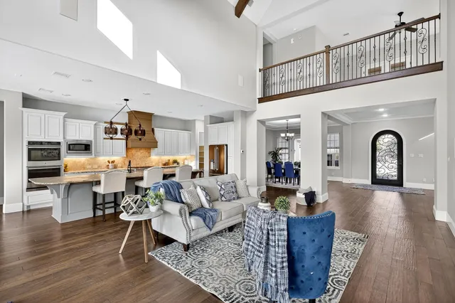 a living room with furniture or kitchen view and a wooden floor