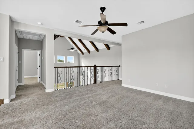 a view of staircase with railing and a chandelier