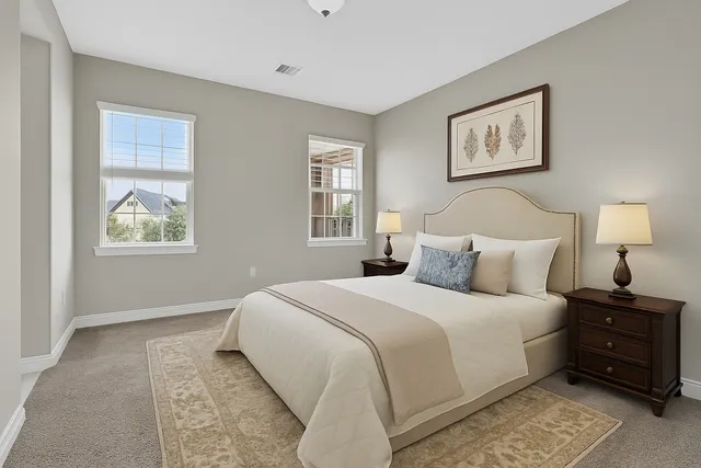 a bedroom with a bed and a night stand