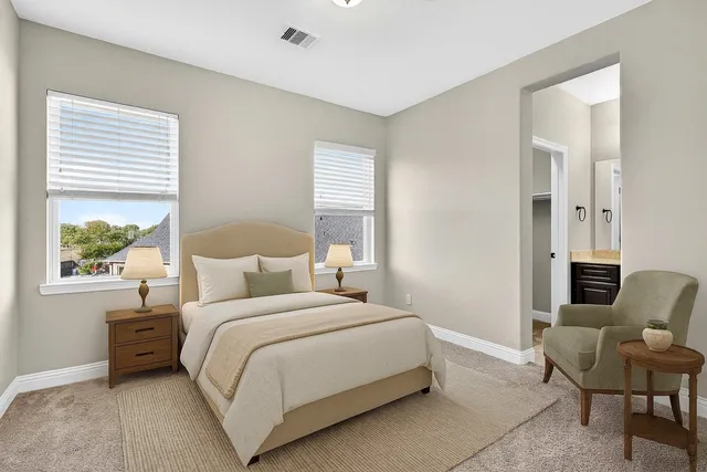 a bedroom with a bed chair and a window