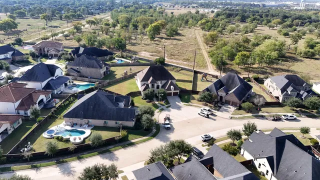 an aerial view of a house with a yard and lake view