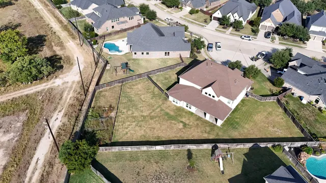 an aerial view of residential houses with outdoor space