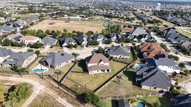 an aerial view of residential houses with outdoor space