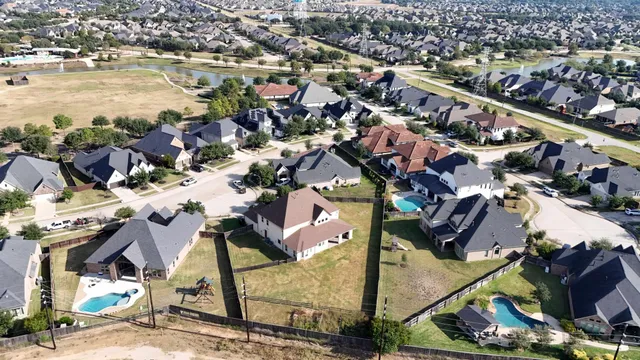 an aerial view of residential houses with outdoor space