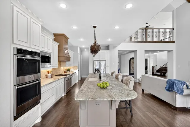 a kitchen with a sink stainless steel appliances furniture and kitchen view