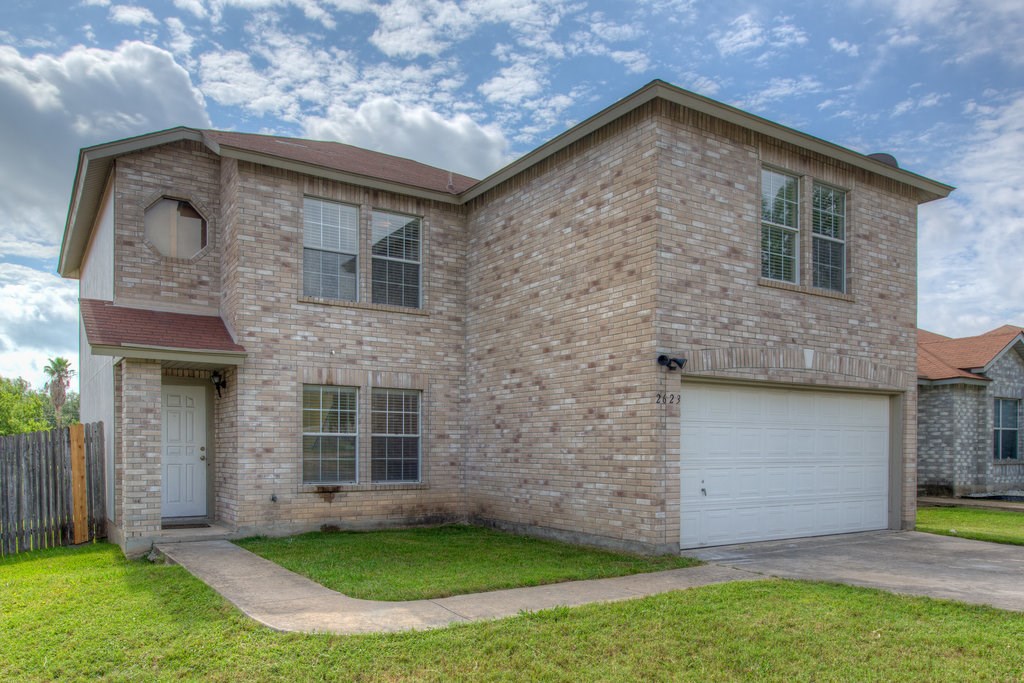 2623 Andres Way Round Rock, TX 78664 - Photo 2 of 15 a front view of a house with a yard and garage