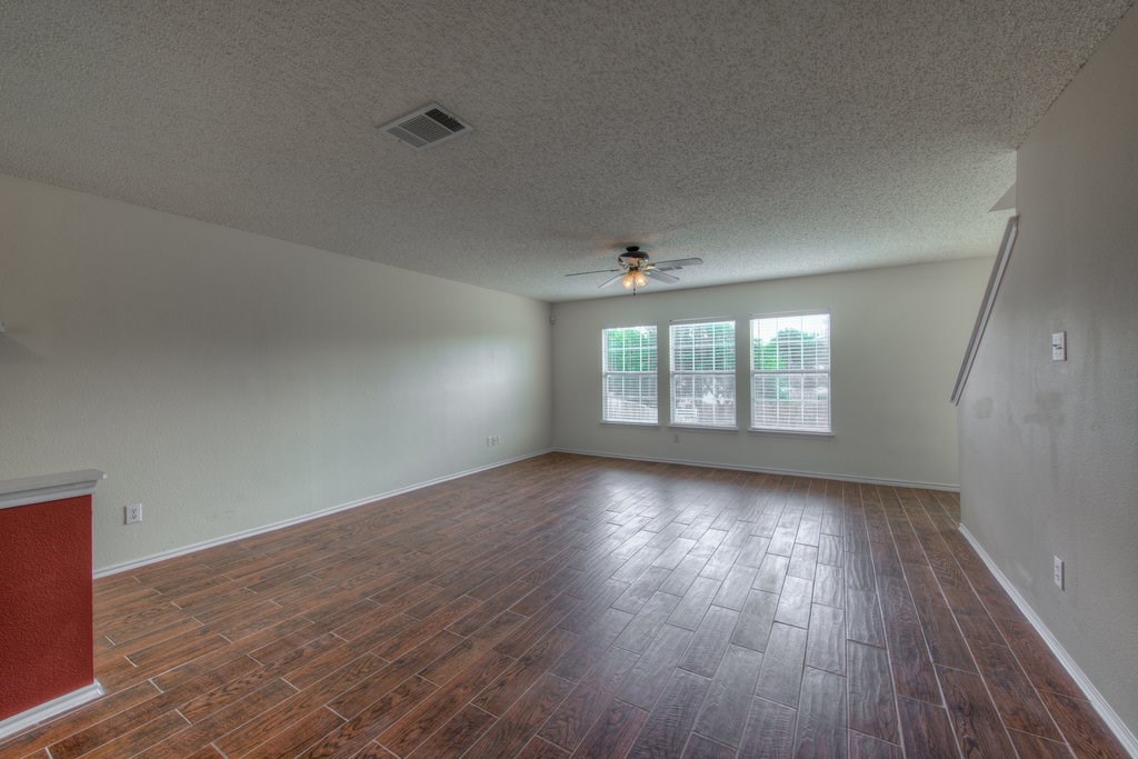 2623 Andres Way Round Rock, TX 78664 - Photo 4 of 15 an empty room with wooden floor and windows