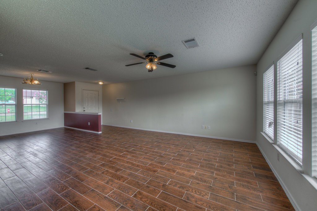 2623 Andres Way Round Rock, TX 78664 - Photo 5 of 15 an empty room with wooden floor and windows