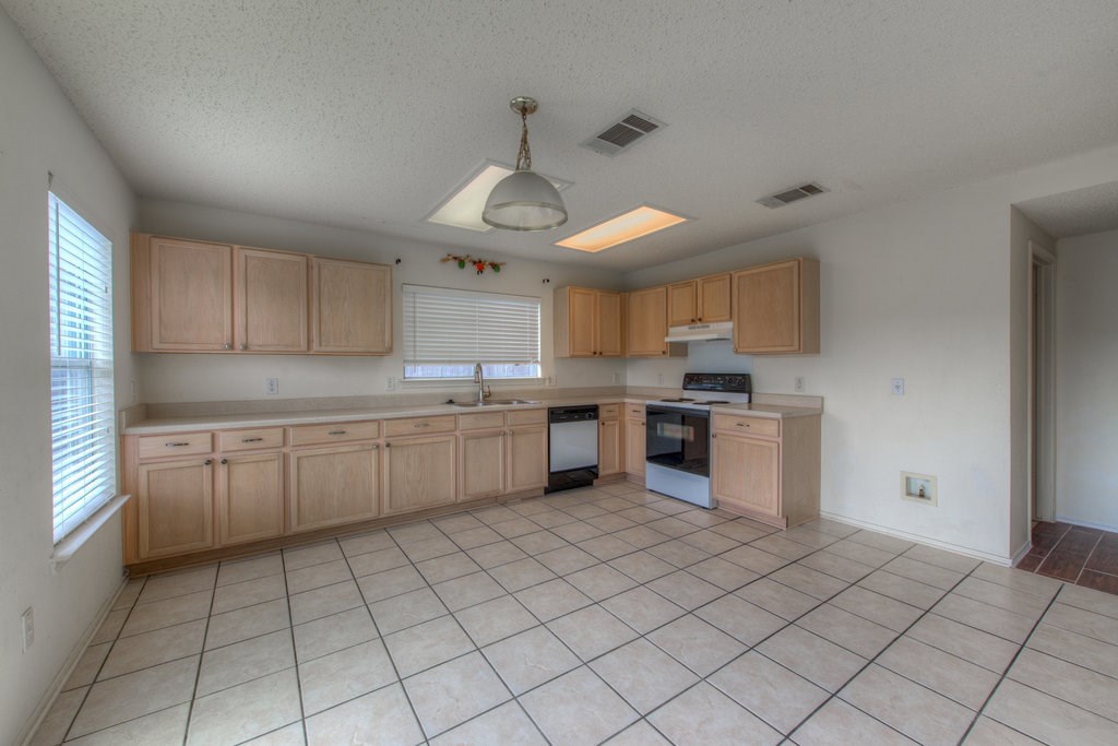 2623 Andres Way Round Rock, TX 78664 - Photo 6 of 15 a kitchen with a sink window and cabinets