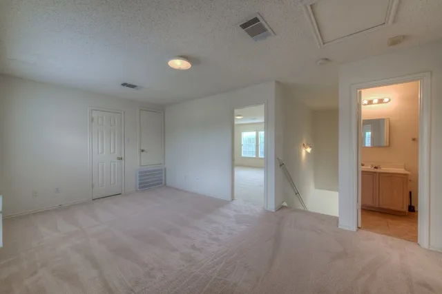 an empty room with fan and mirror