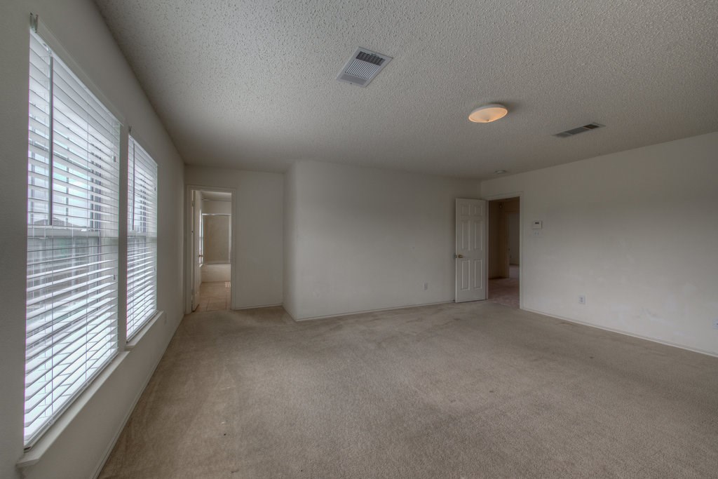 2623 Andres Way Round Rock, TX 78664 - Photo 10 of 15 en empty room with windows and entrance