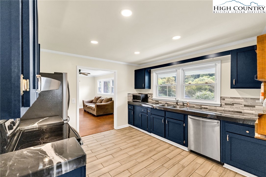 358 Dogget Road West Jefferson, NC 28694 - Photo 11 of 41 a kitchen with stainless steel appliances granite countertop a sink and wooden cabinets