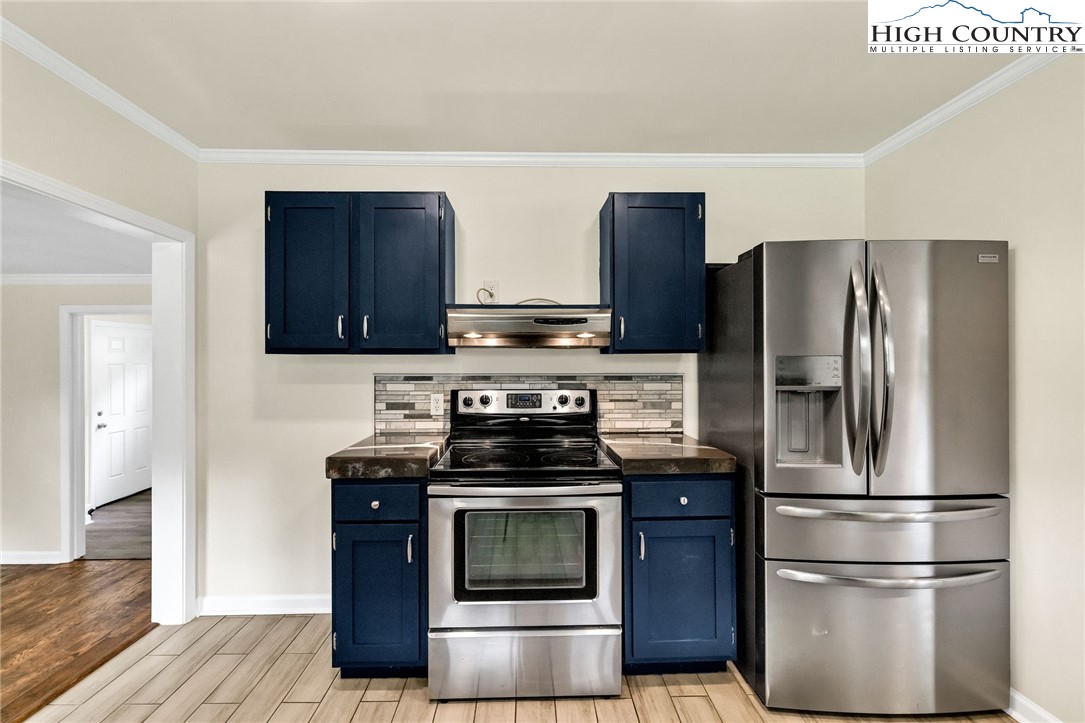 358 Dogget Road West Jefferson, NC 28694 - Photo 14 of 41 a kitchen with stainless steel appliances granite countertop a stove a refrigerator and a microwave