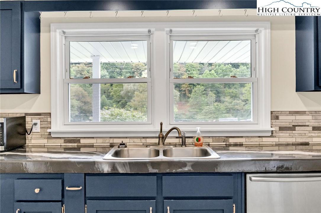 358 Dogget Road West Jefferson, NC 28694 - Photo 15 of 41 a kitchen with granite countertop a sink and a window