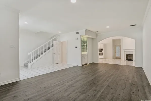 a view of empty room with wooden floor