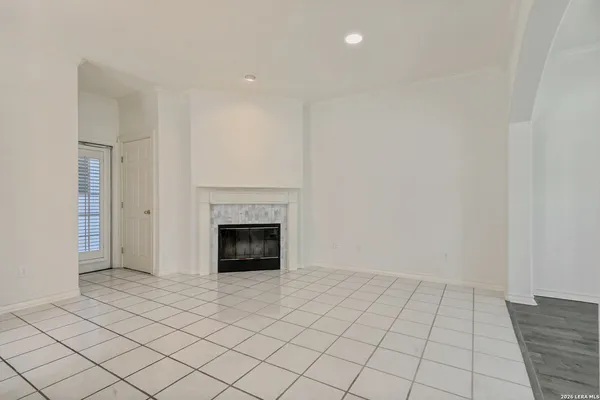 a view of an empty room with a fireplace