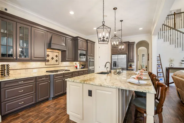 a kitchen with center island cabinets and wooden floor