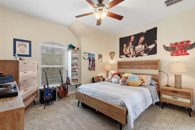 a bedroom with furniture and a chandelier