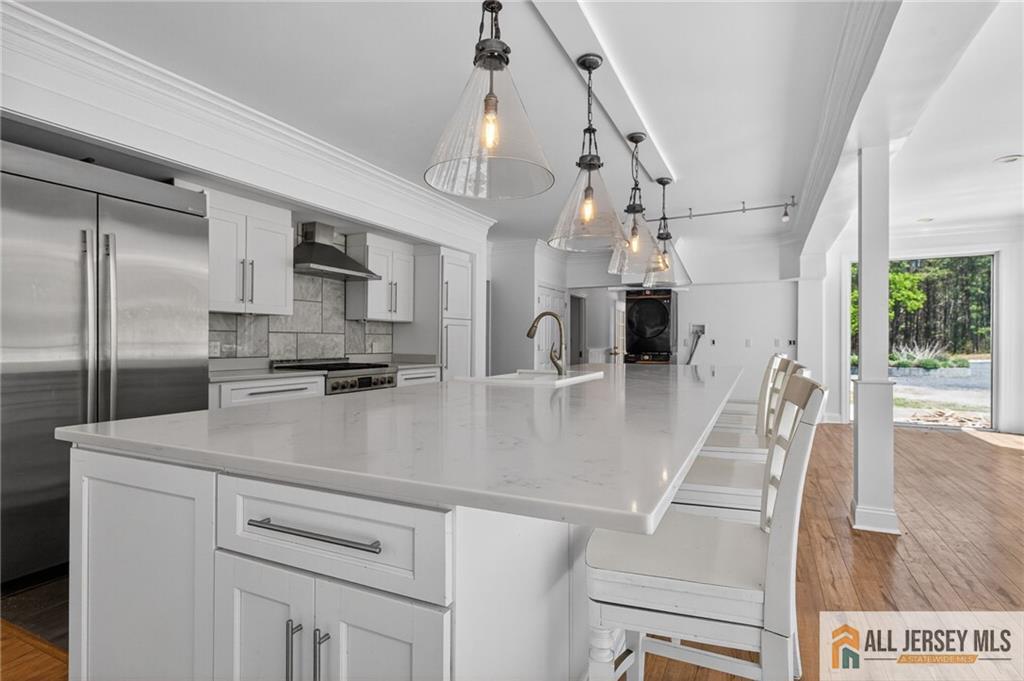 381 Monmouth Road Freehold, NJ 07728 - Photo 16 of 63 a view of a kitchen with kitchen island a counter top space cabinets and stainless steel appliances