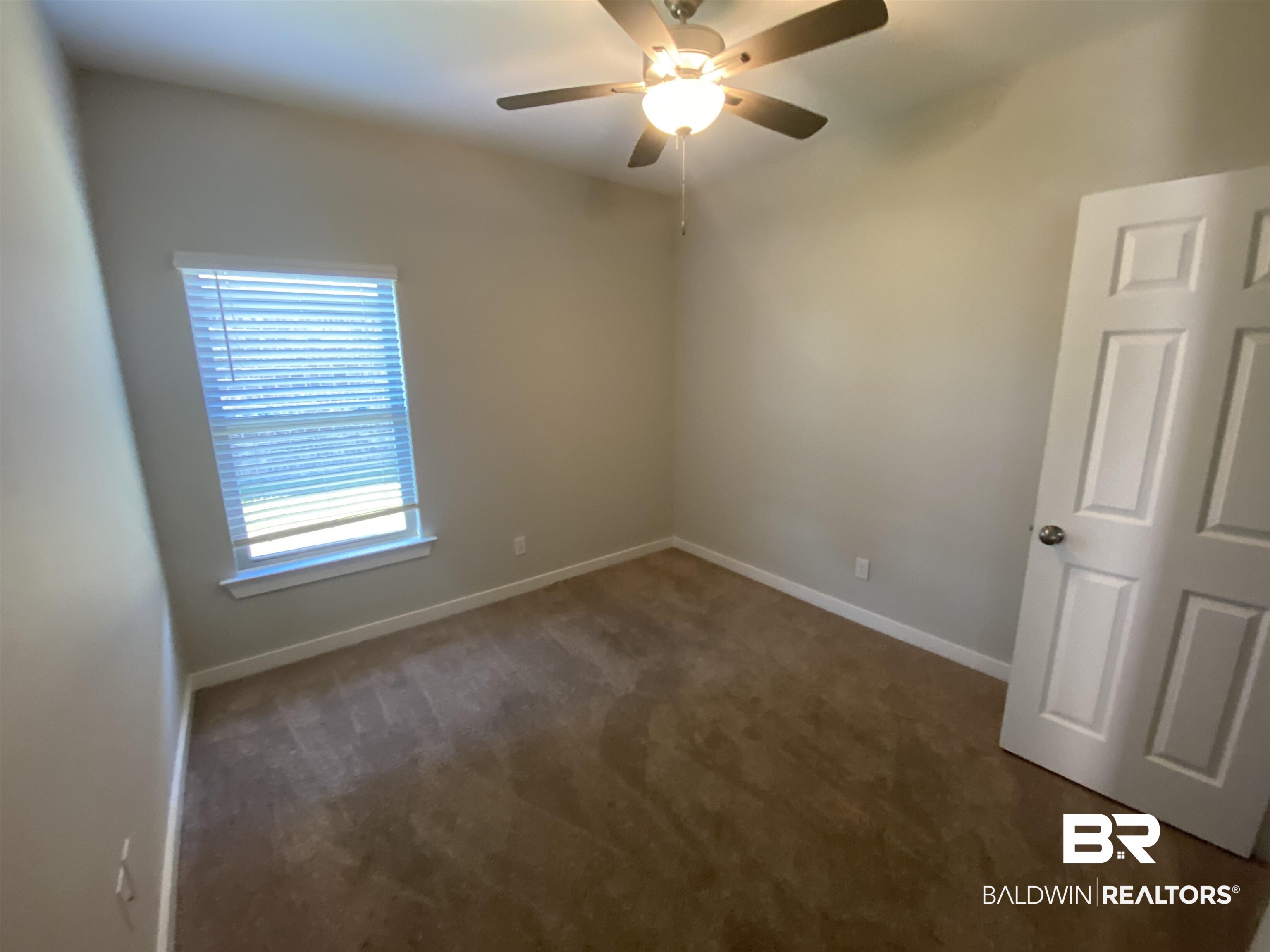 1279 Cater Lee Way Foley, AL 36535 - Photo 4 of 12 Spare room with ceiling fan and dark colored carpet