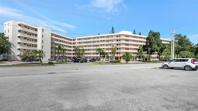 a city street with tall buildings in the background