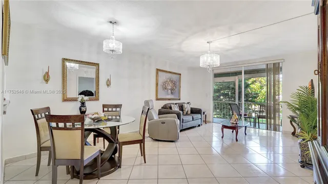 a living room with furniture a dining table and paintings on the wall