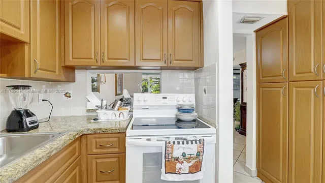 a kitchen with stainless steel appliances granite countertop cabinets and window