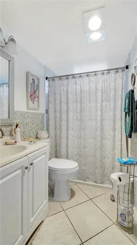 a view of a swimming pool with lawn chairs and a big yard