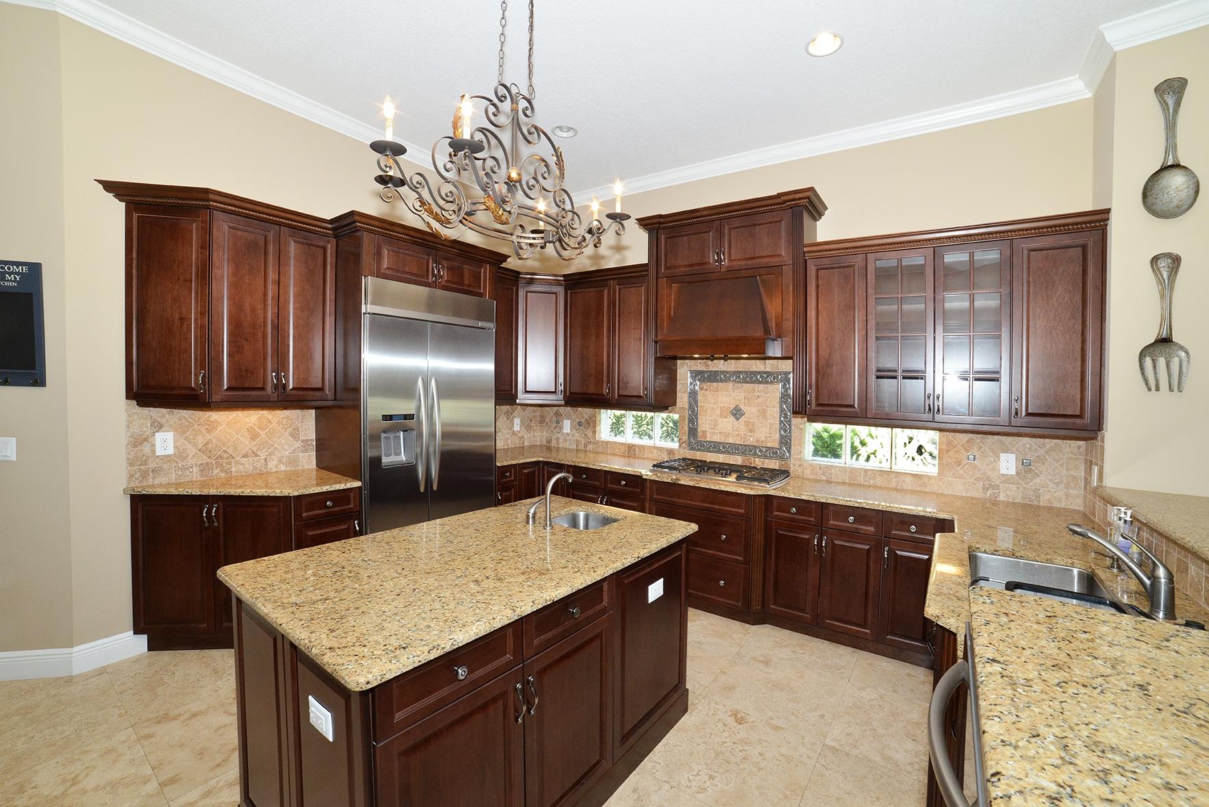 9812 Equus Circle Boynton Beach, FL 33472 - Photo 14 of 39 a kitchen with kitchen island granite countertop stainless steel appliances a sink stove and refrigerator