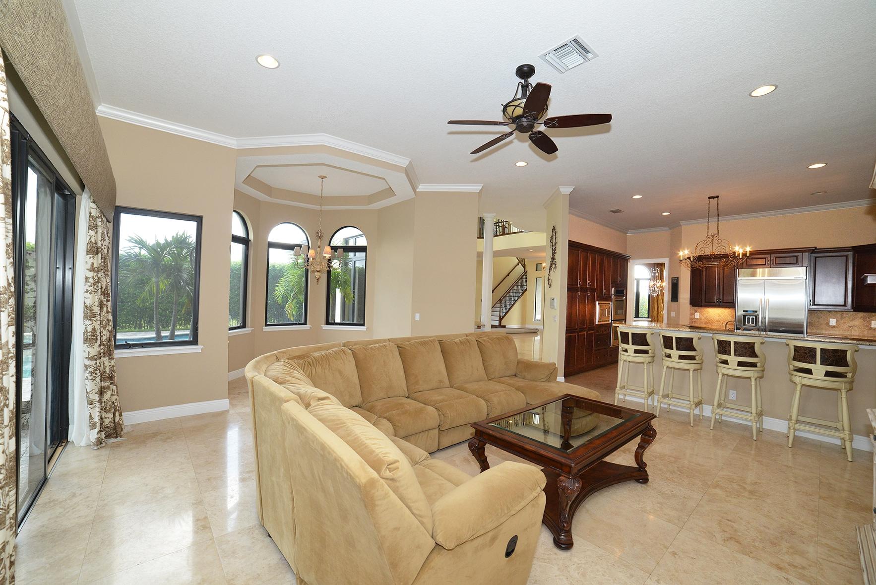 9812 Equus Circle Boynton Beach, FL 33472 - Photo 18 of 39 a living room with furniture kitchen area and a large window