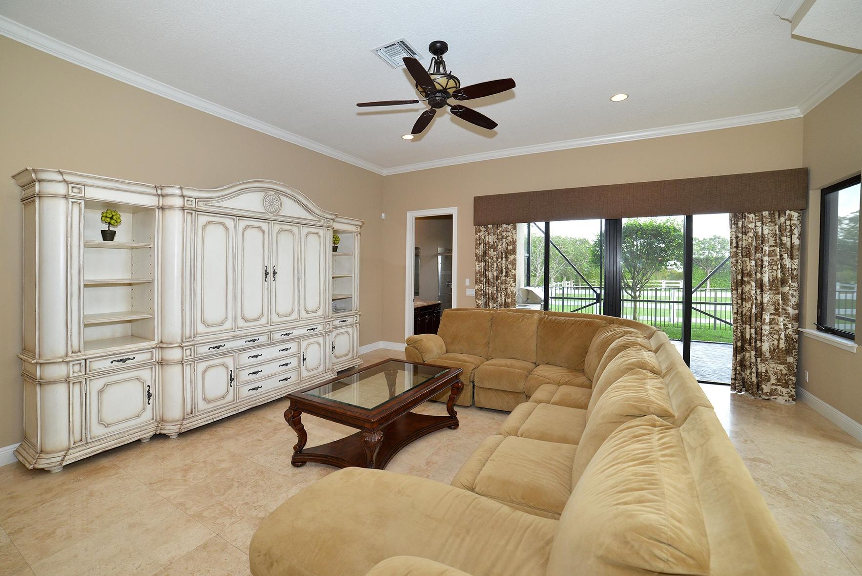 9812 Equus Circle Boynton Beach, FL 33472 - Photo 19 of 39 a living room with furniture and large windows