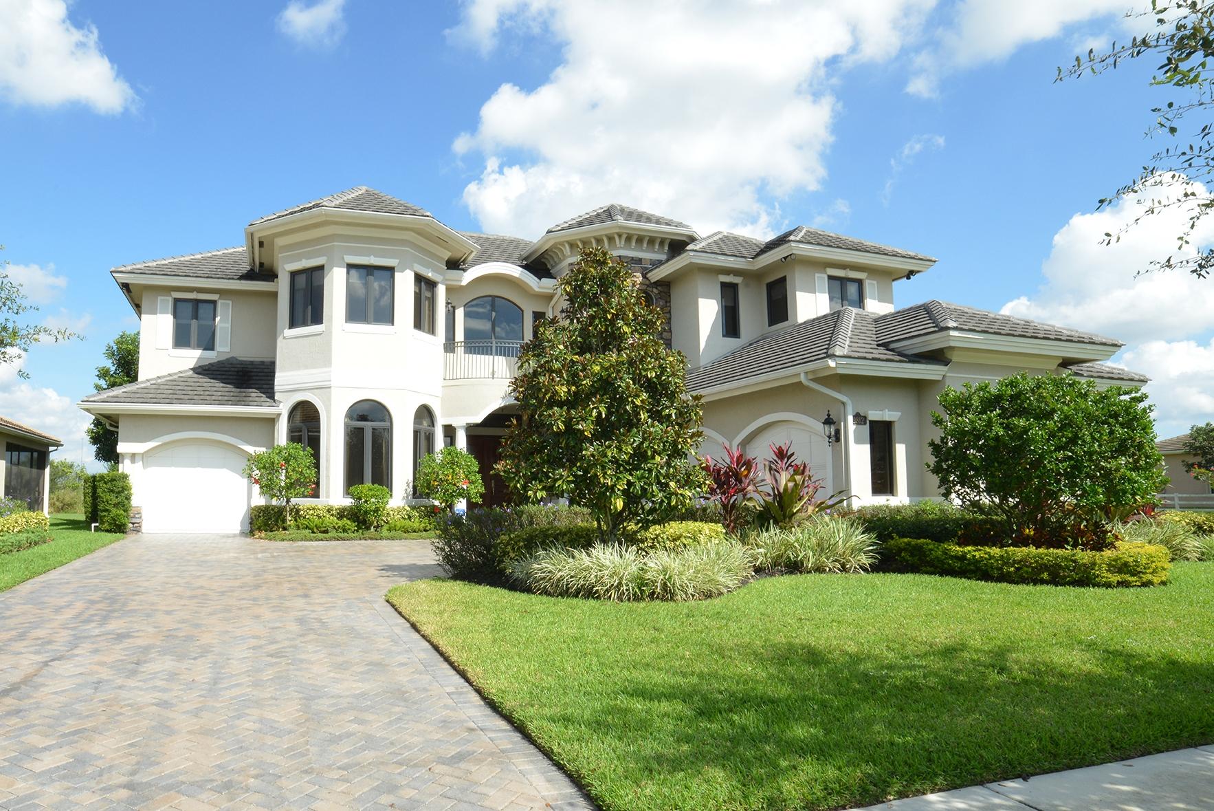 9812 Equus Circle Boynton Beach, FL 33472 - Photo 3 of 39 a front view of a house with a yard