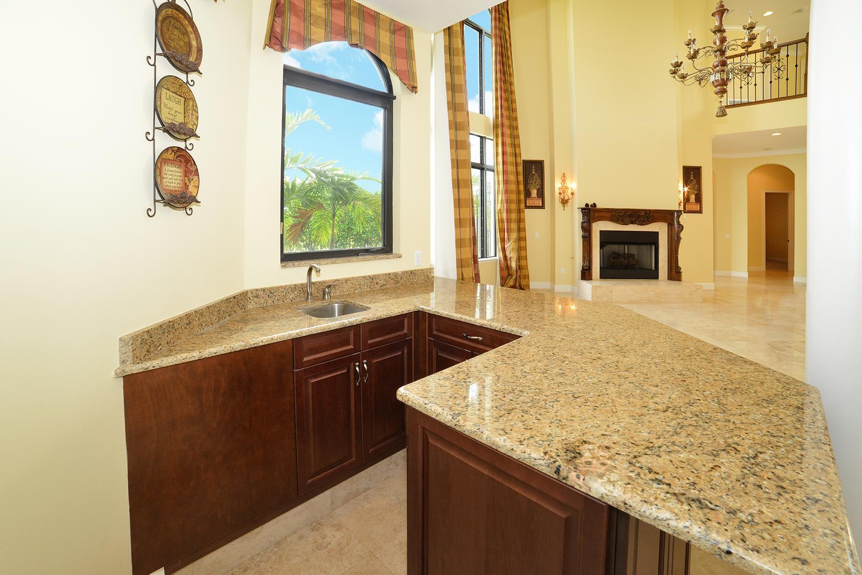9812 Equus Circle Boynton Beach, FL 33472 - Photo 22 of 39 a kitchen with a sink a stove and a wooden floor