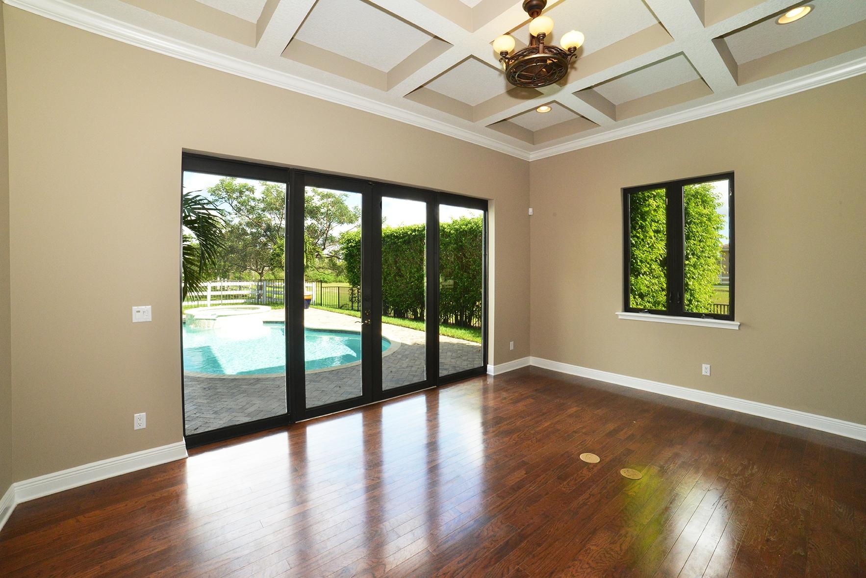 9812 Equus Circle Boynton Beach, FL 33472 - Photo 23 of 39 a view of an empty room with wooden floor and a window