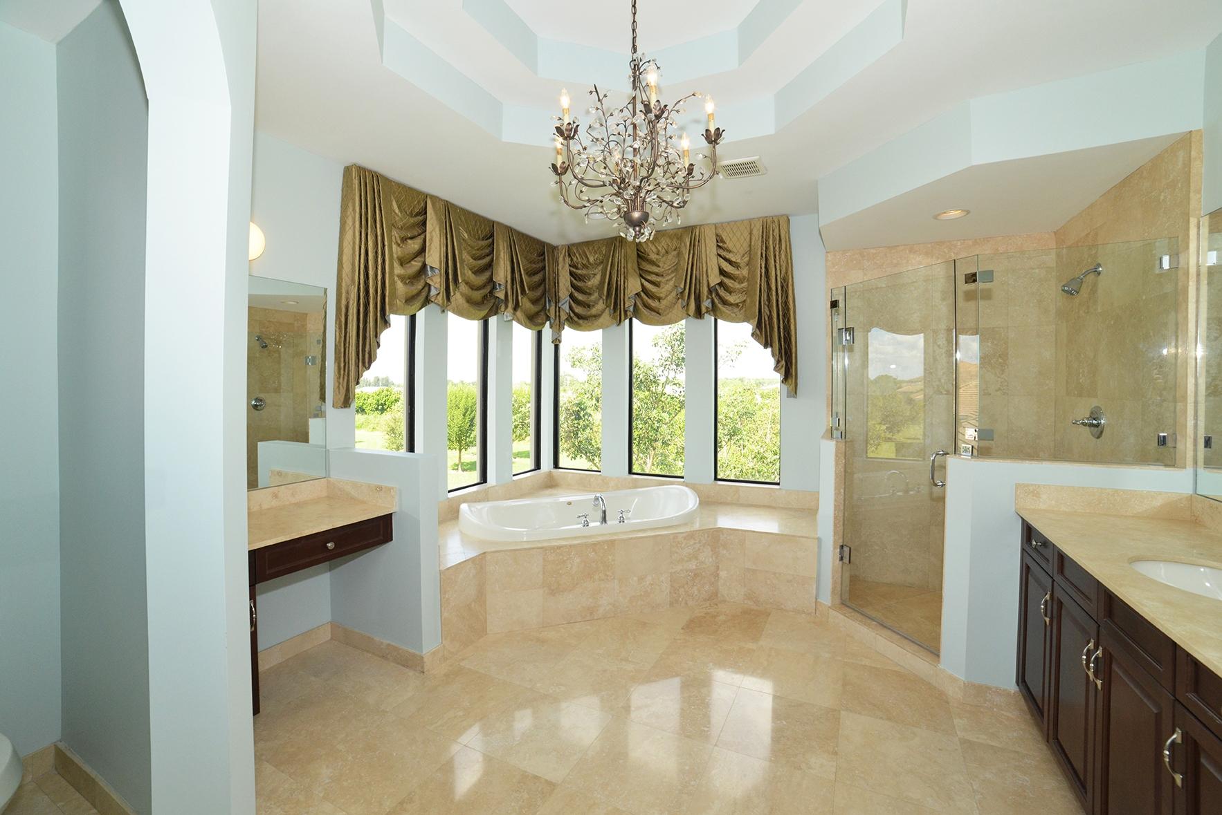 9812 Equus Circle Boynton Beach, FL 33472 - Photo 28 of 39 a spacious bathroom with a granite countertop tub shower and sink