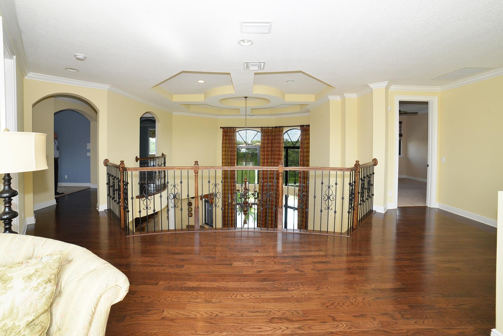 9812 Equus Circle Boynton Beach, FL 33472 - Photo 32 of 39 a view of a living room and chandelier with kitchen view