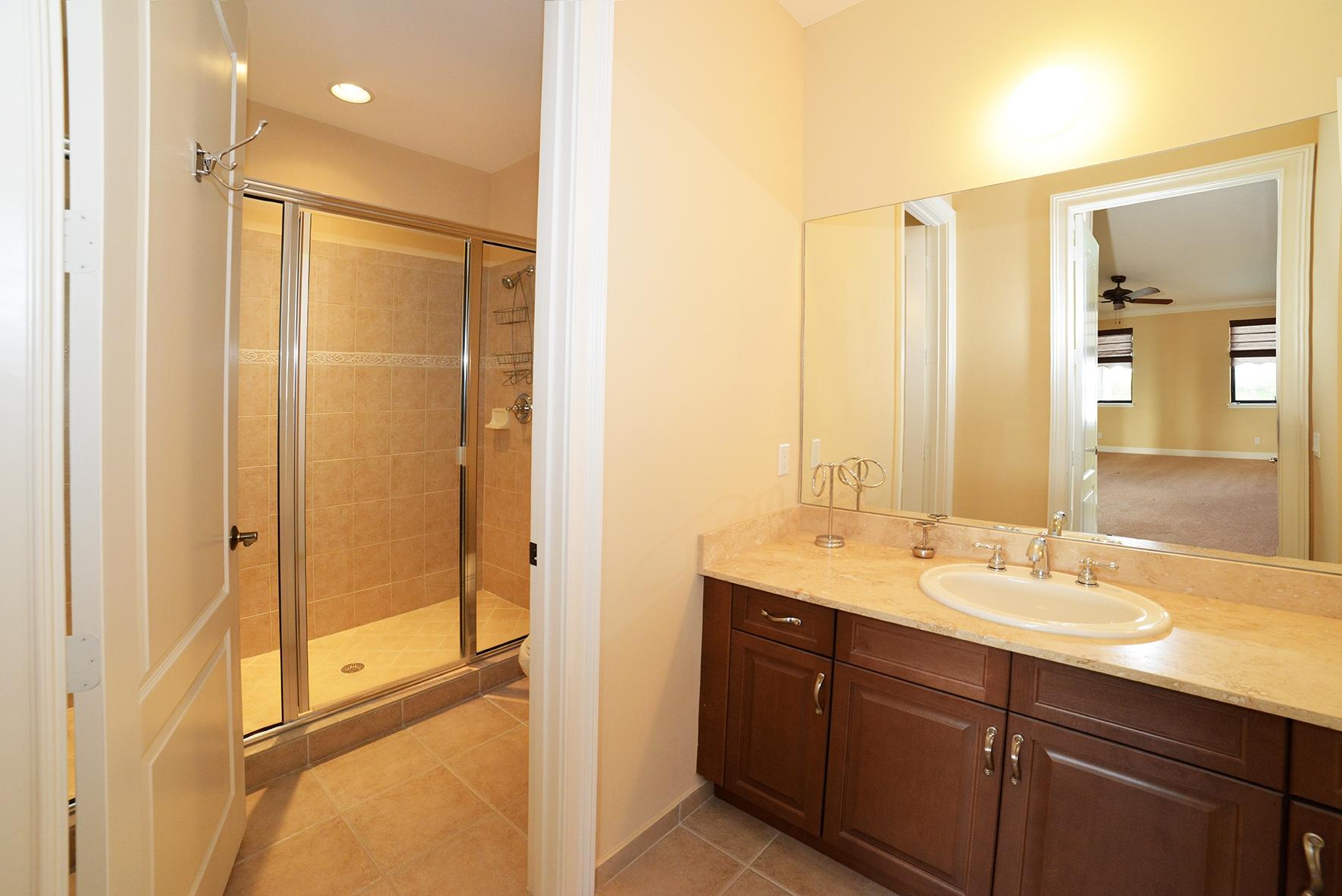 9812 Equus Circle Boynton Beach, FL 33472 - Photo 36 of 39 a bathroom with a double vanity sink mirror and shower