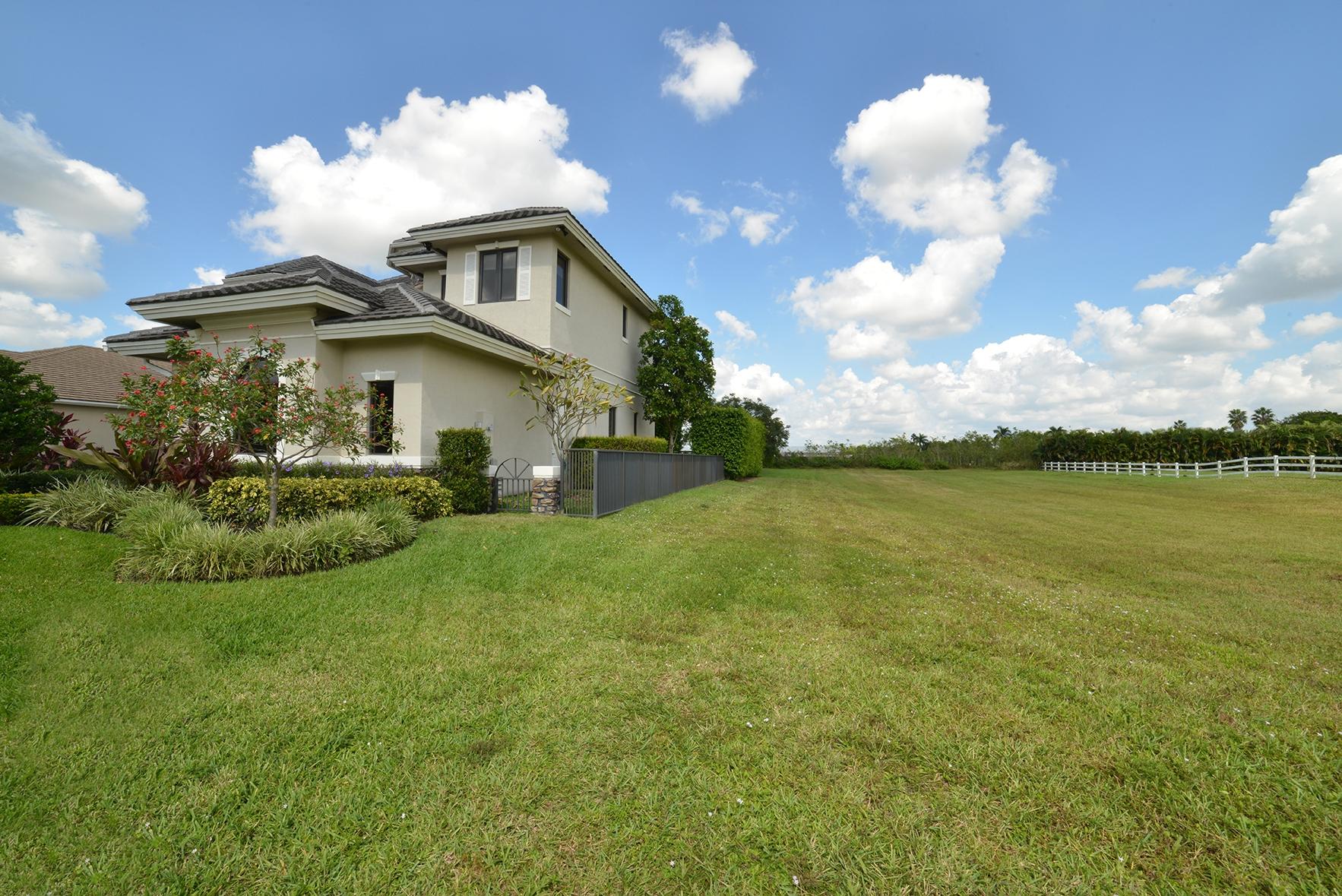 9812 Equus Circle Boynton Beach, FL 33472 - Photo 7 of 39 a front view of a house with garden