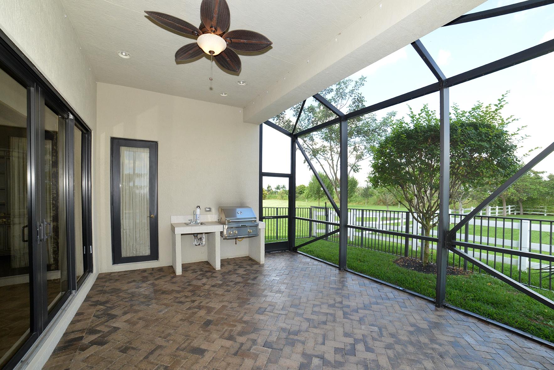 9812 Equus Circle Boynton Beach, FL 33472 - Photo 10 of 39 a view of a porch with furniture and garden