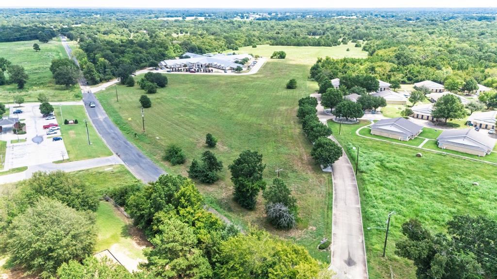 83-ac Stillhouse Road Paris, TX 75462 - Photo 22 of 22 an aerial view of residential houses with outdoor space and trees