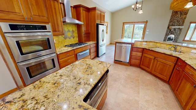 a view of empty room with fireplace and wooden floor