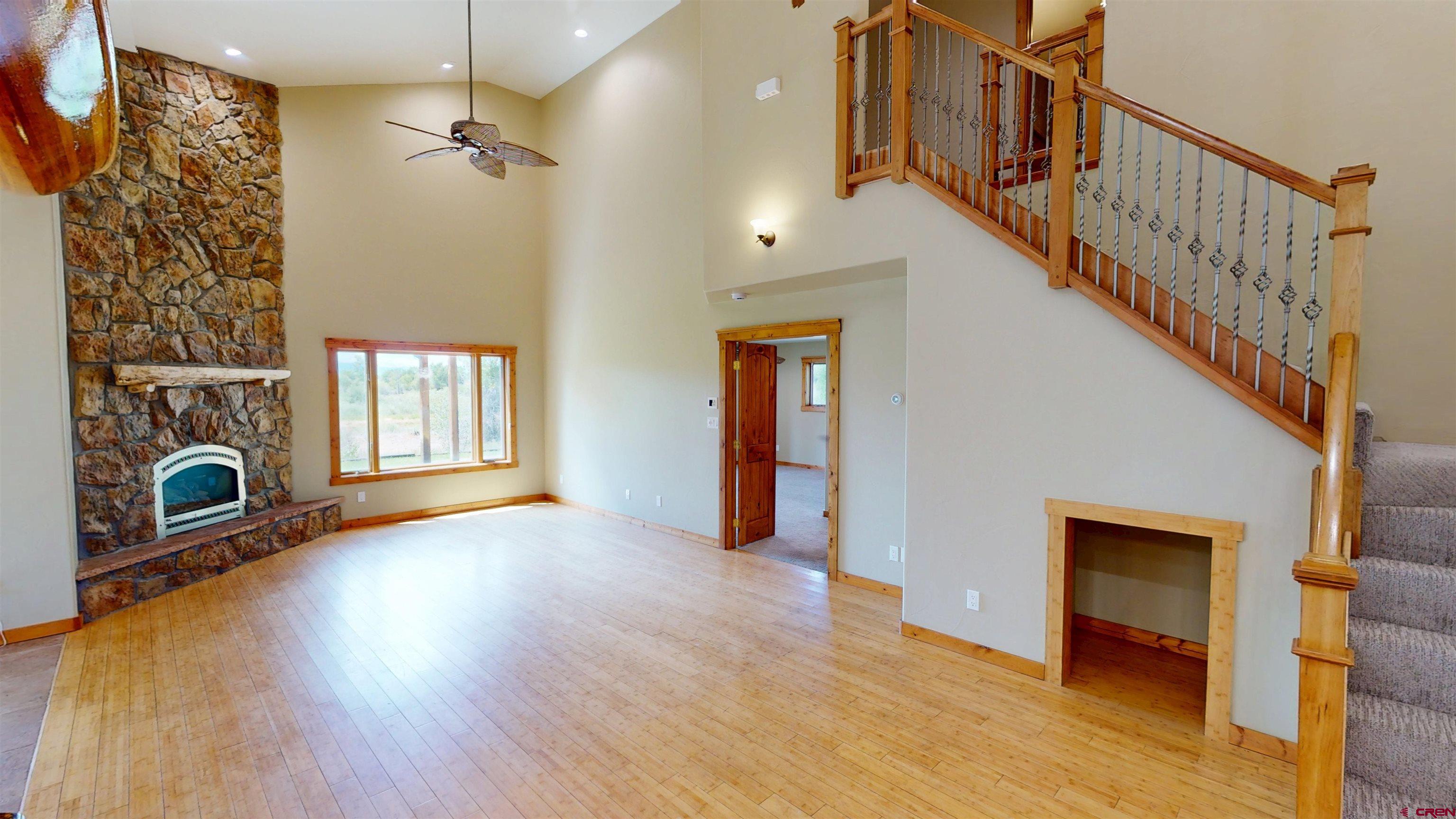 7857 Oxbow Loop Alamosa, CO 81101 - Photo 12 of 24 a view of empty room with fireplace and wooden floor
