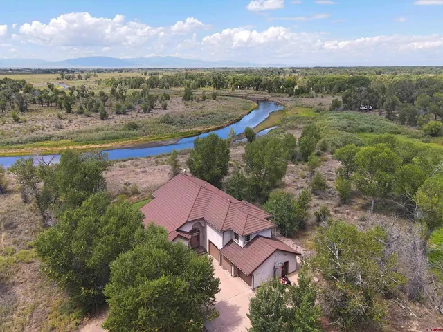 an aerial view of residential houses with outdoor space and city view