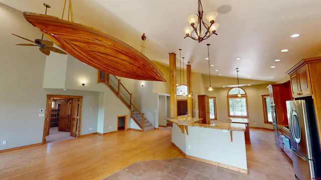 a large kitchen with stainless steel appliances granite countertop a stove and large refrigerator