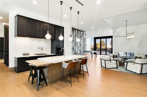 a living room with furniture a flat screen tv and floor to ceiling window