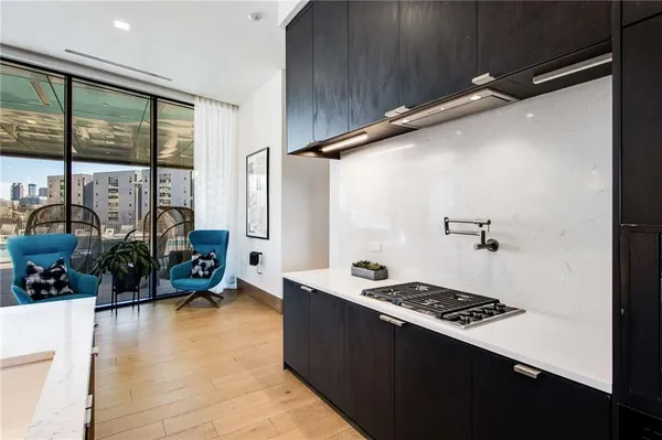 a living room with furniture kitchen view and large windows