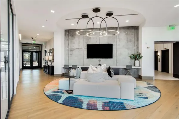 a living room with furniture and floor to ceiling window