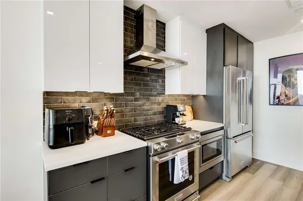 a kitchen with stainless steel appliances a stove and a refrigerator